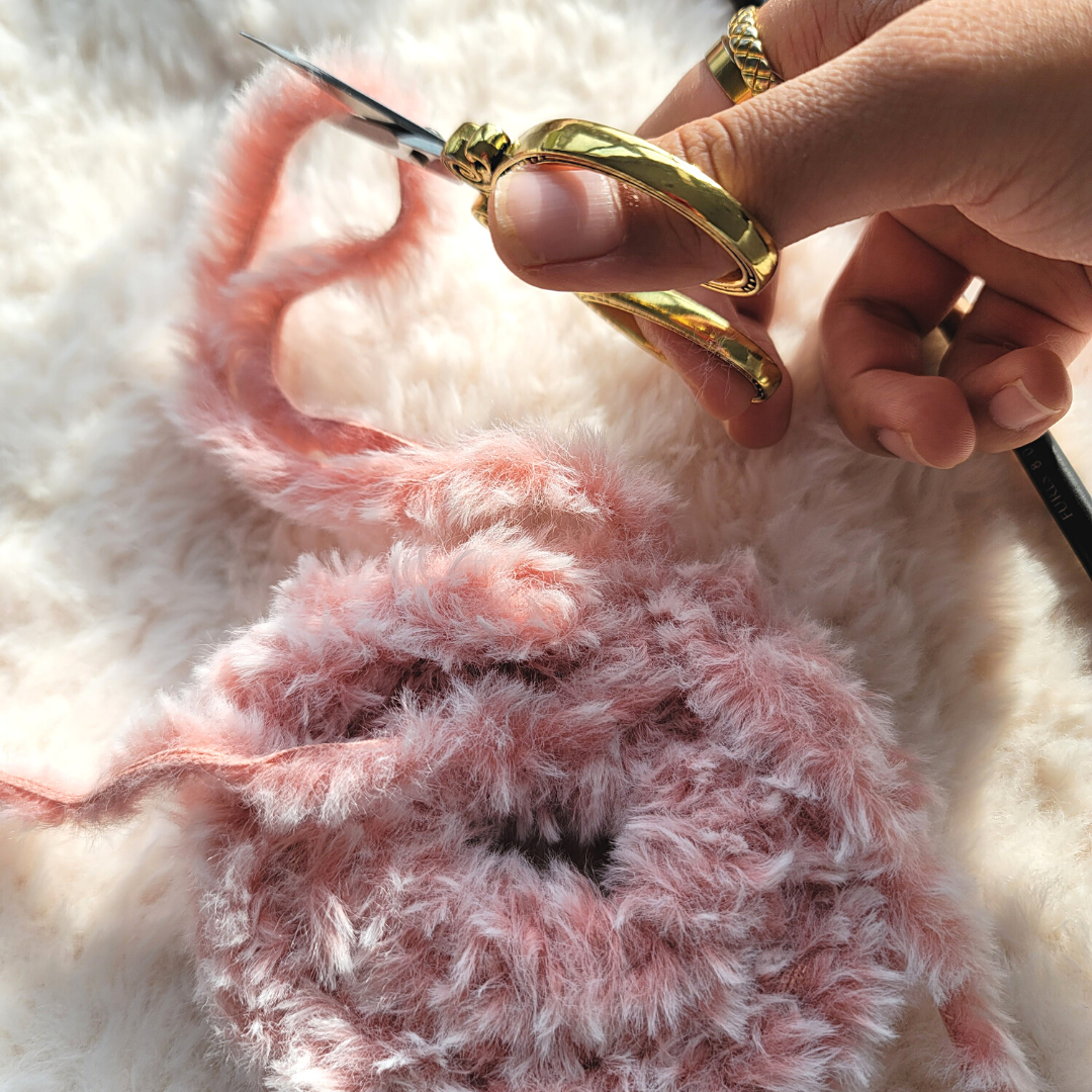 Check out this easy free scrunchie crochet pattern. A quick and free Tunisian crochet pattern made with faux fur yarn.