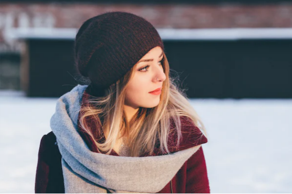 woman with beanie and scarf outside in snow