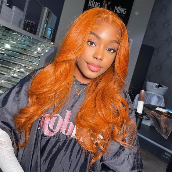 Pretty woman wearing long orange wavy wig