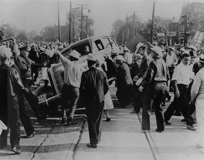 A group of people fighting over a car