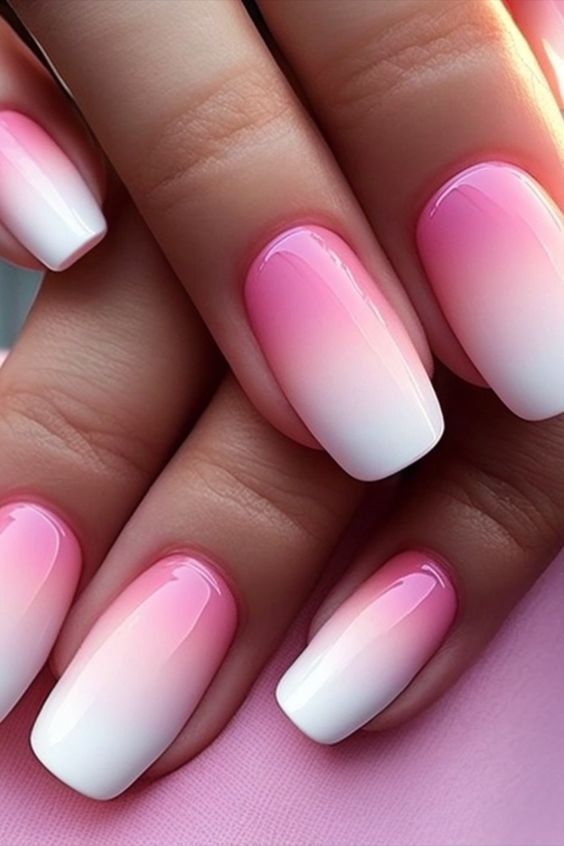 Close up view of  a pink and white nails   with the ombre effect