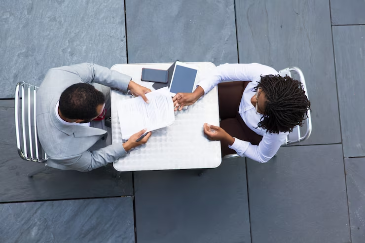 Two individuals engaged in a mock medical school interview.