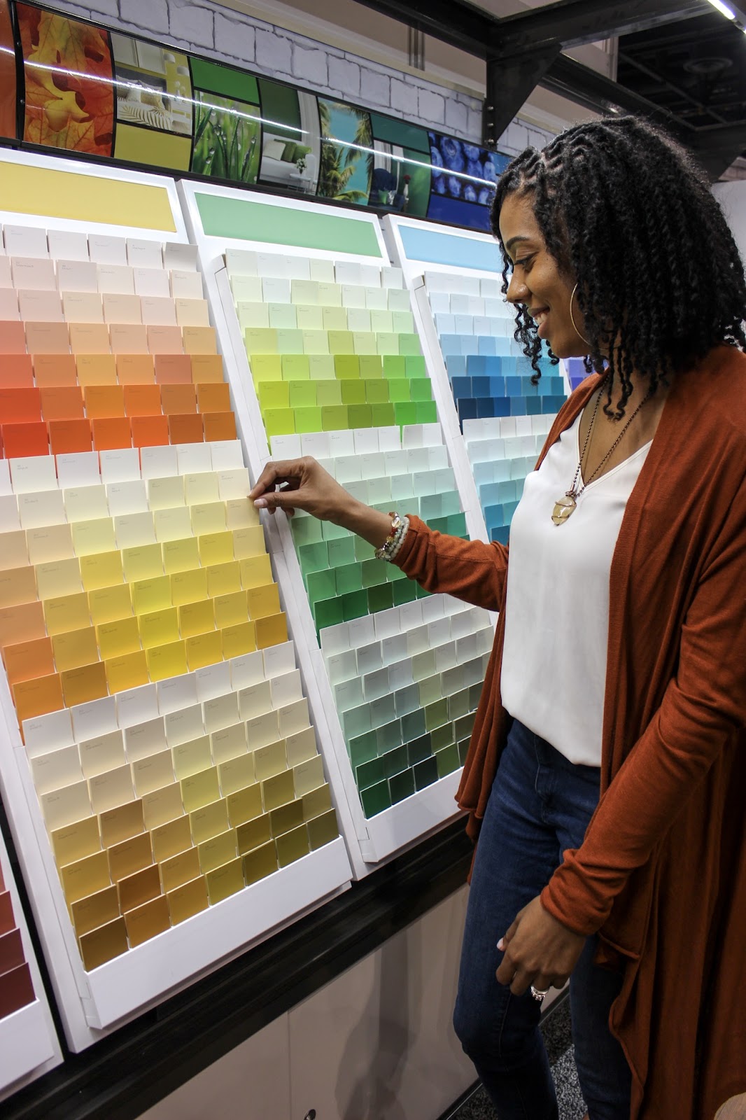 Girl looking at paint samples very colorful