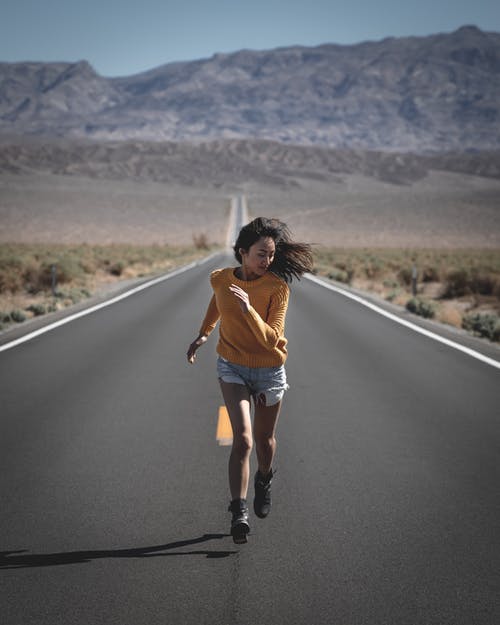 Photo of Woman Running on Road