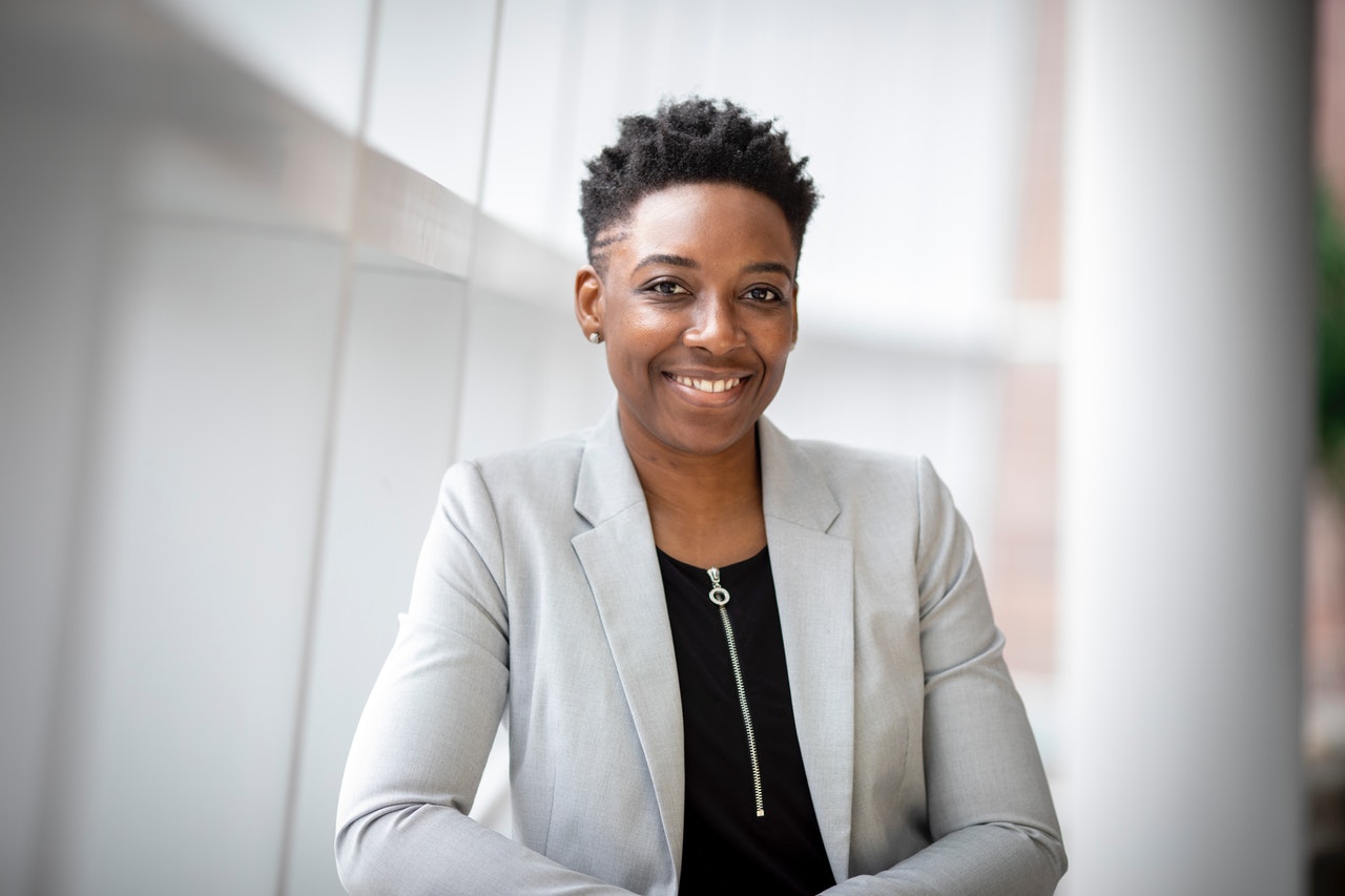 A young professional-looking Black woman smiling