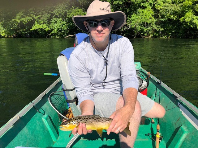 Chris in a Canoe with Brown Trout