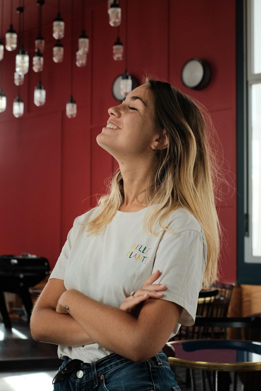 woman in white crew neck t-shirt sitting on chair