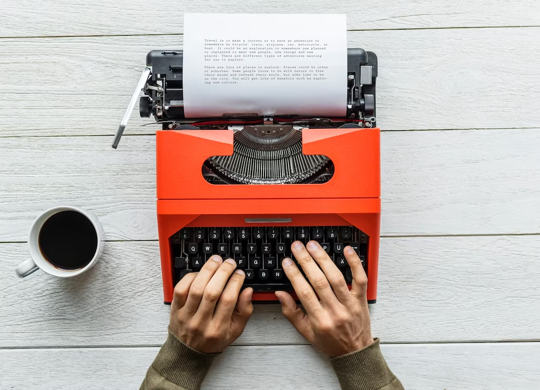 A person writing on a typewriter