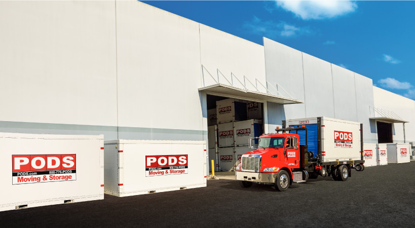 A PODS truck delivering a PODS portable storage container to a secure PODS Storage Center to be stored while the customer is away at college.