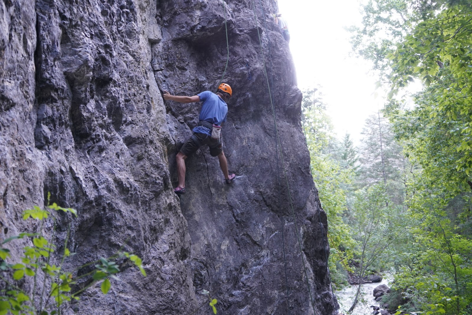 young man rock climbing