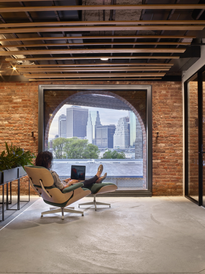 Comfy lounge chair facing a large window with a view of the city in United Technologies' office in New York
