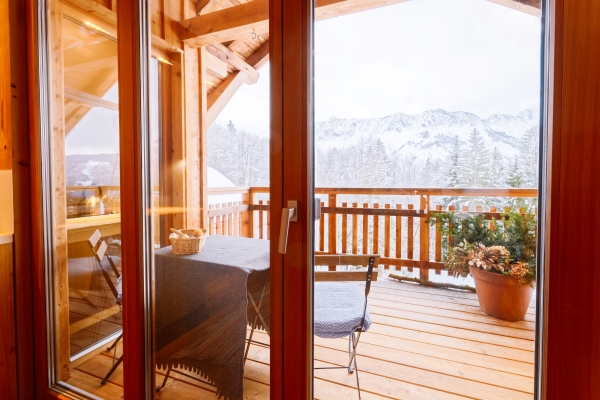 view-from-balcony-living-room-austrian-alps-mountain-snow-winter-design-modern-apartment-house-with-open-terrace-alpine-scenery-austria-decor-stylish-lifestyle-table-with-chairs