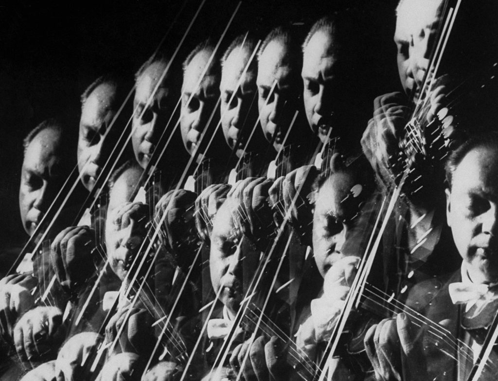 Stroboscopic image showing a repetitive closeup of Isaac Stern playing violin at photographer Gjon Mili`s studio in 1959.