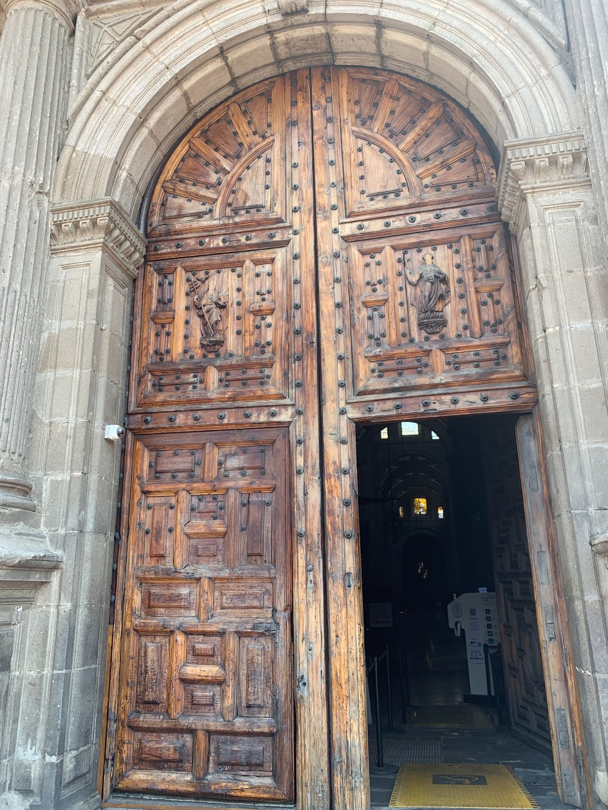 Photo of the entrance of Mexico City’s Metropolitan Cathedral. They are made of large antiquated wood.