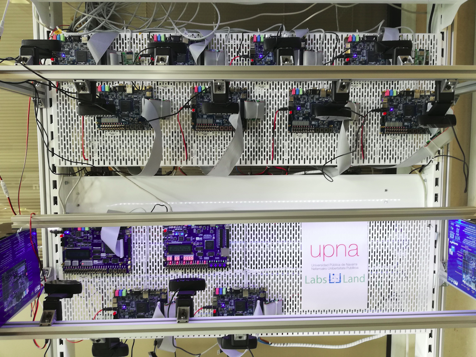 FPGA boards deployed in a vertical panel at UPNA.