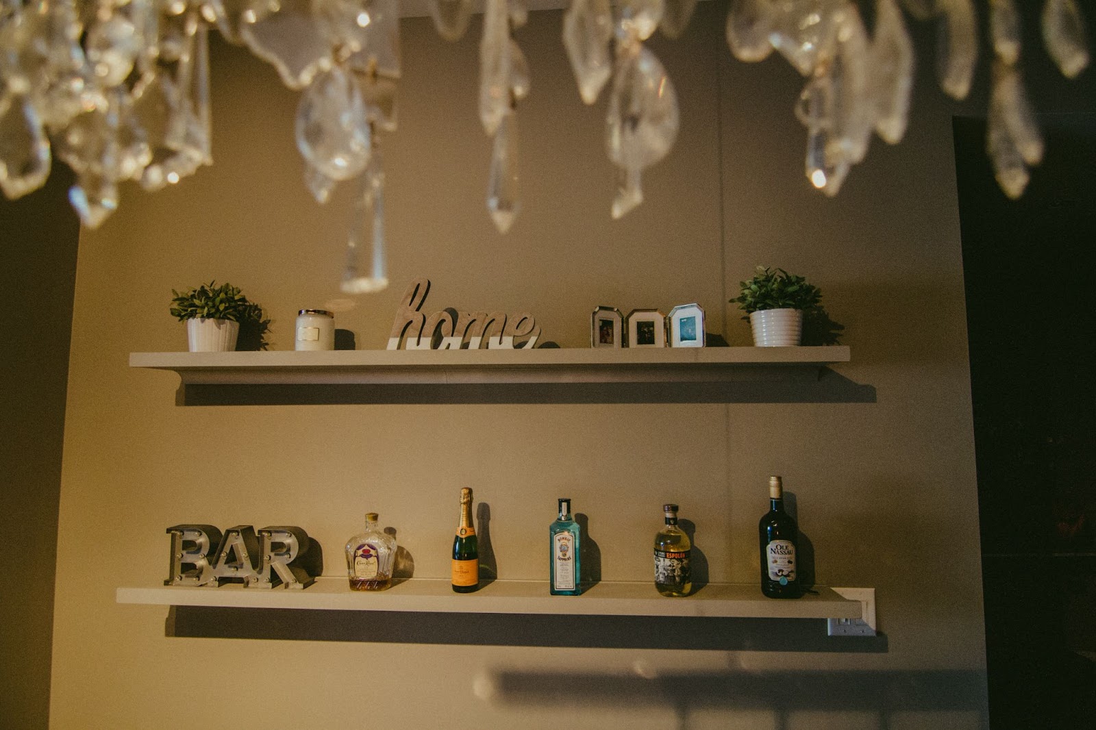 Two shelves with home bar decor