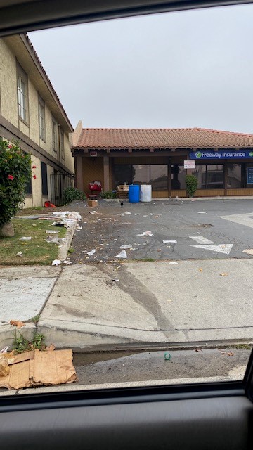 A photo of a driveway filled with trash