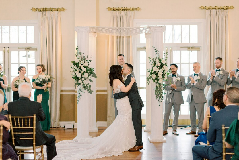 Couple share an embrace at the end of their wedding ceremony