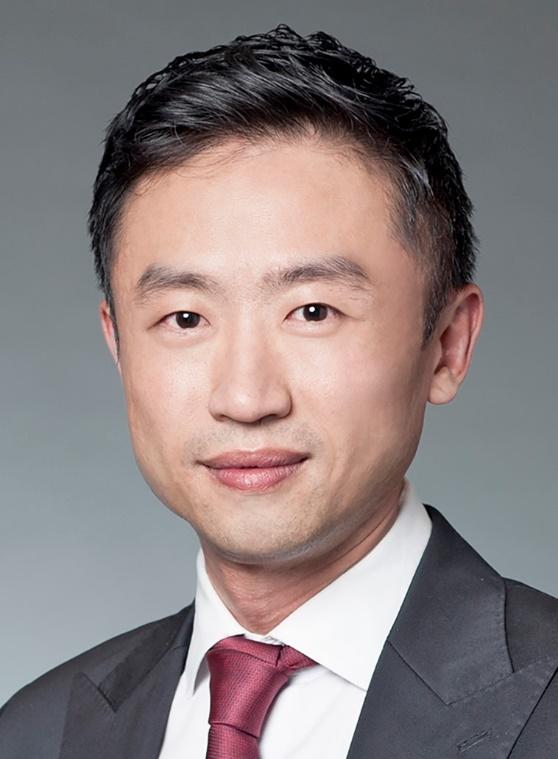 A person in a suit and tie
Description automatically generated with medium confidence
