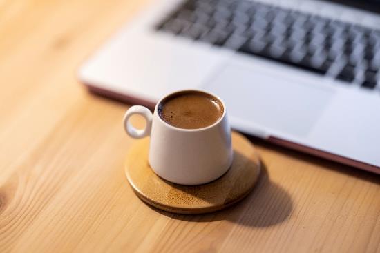 A cup of coffee on a coaster

Description automatically generated with medium confidence