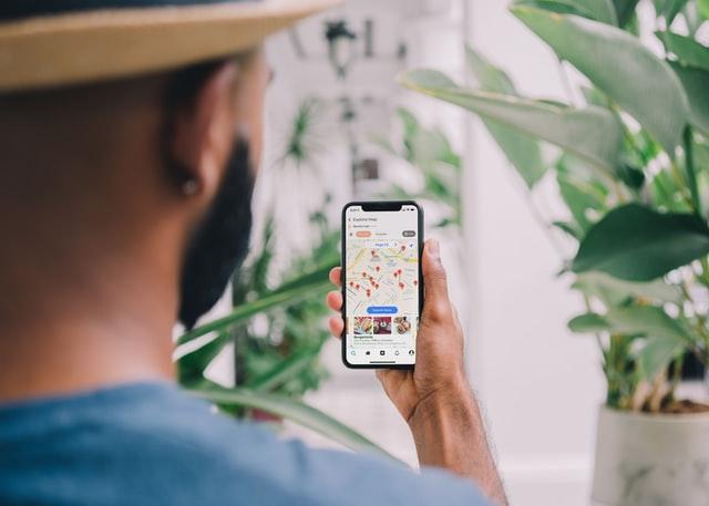 A man looking at google maps and planning the ultimate staycation