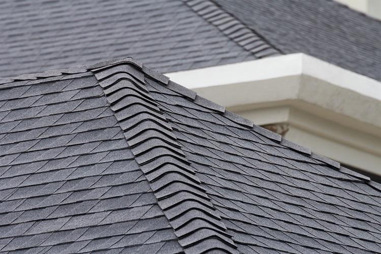 WeServe different type of material; close up of asphalt shingles on the roof of the house