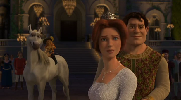 A screen still from Shrek 2, featuring Donkey, as a white stallion, Puss in Boots, and a Human Shrek and Fiona all standing in the castle and looking as they speak to someone off camera.