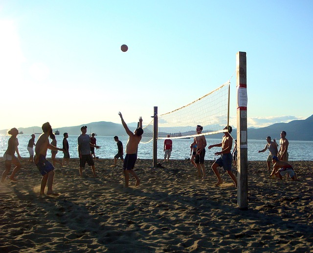 beach side campers engaging in sports activities - things to do while camping with friends