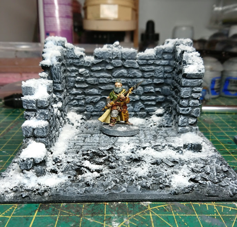 The ruin, with snow effect added and a 28mm model of a barbarian for scale
