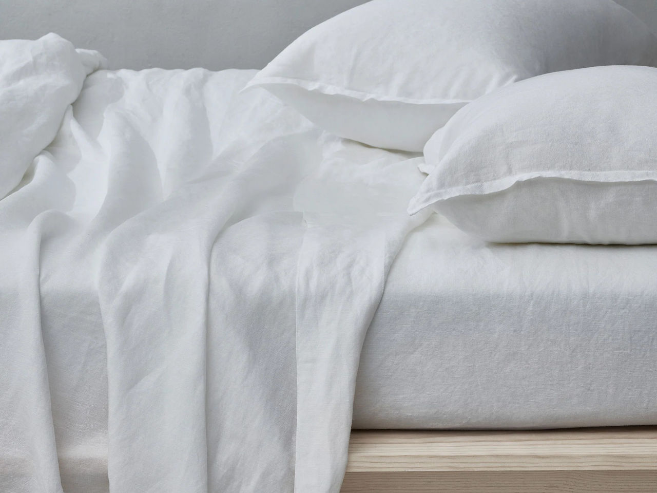 bed with white linen sheets