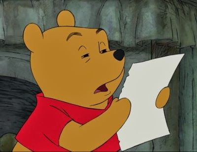 Winnie the Pooh squinting at a piece of paper.