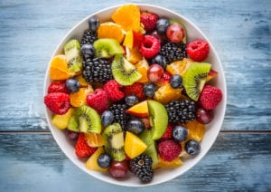 Photograph of a bowl of mixed fruit, including kiwi, oranges, and berries, from "Green Smoothies for Diabetes" at Green Smoothie Girl.