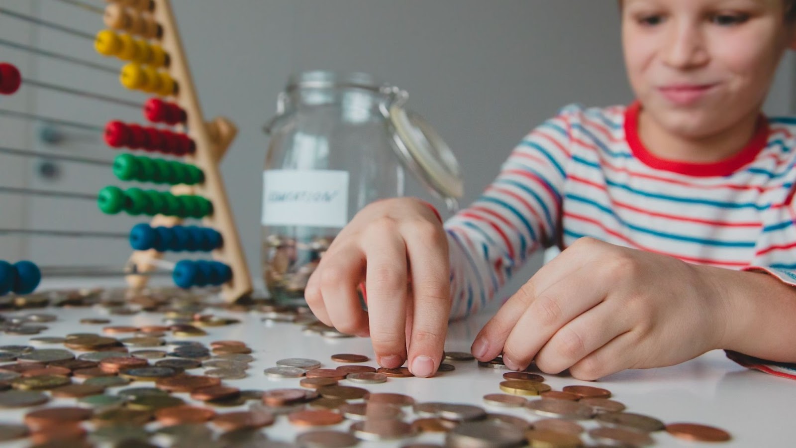boy counting change on a table
