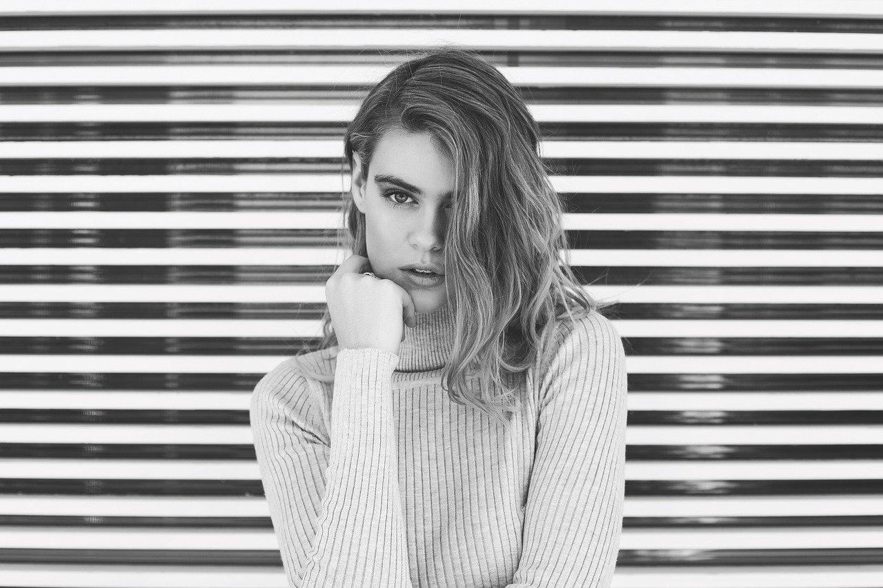 woman standing in front of stripped background