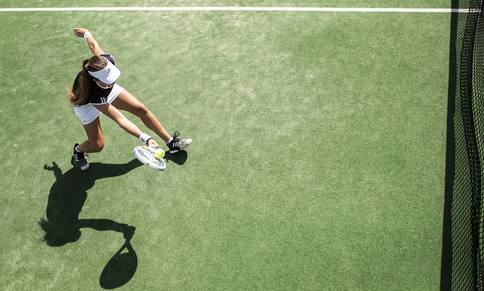 Women playing tennis in the sun