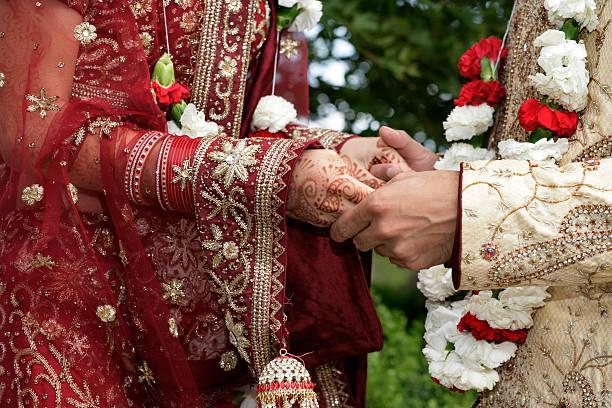 indian groom holding the hands of his bride - indian marriage  stock pictures, royalty-free photos & images