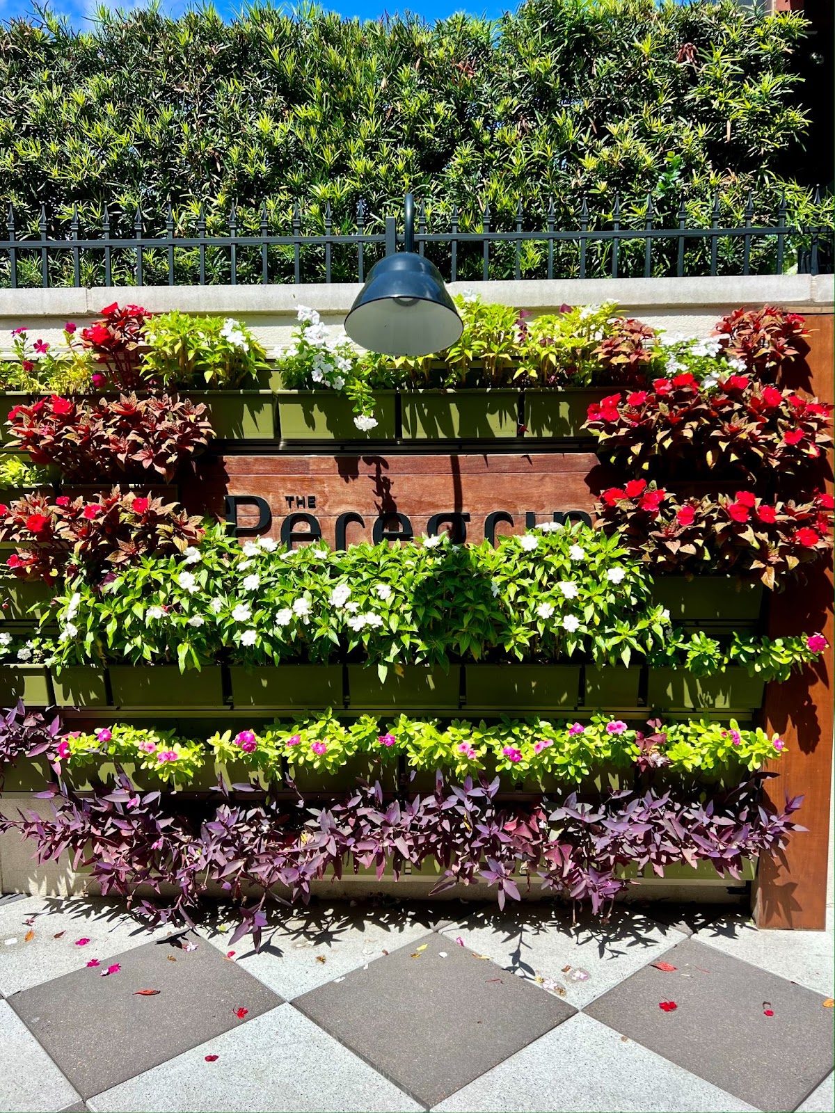 a sign with flowers and a lamp