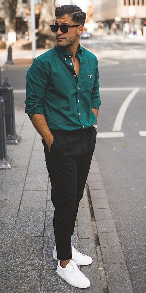 man wearing green shirt and pant with black sunshades and white shoes