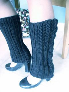 woman wearing black crochet leg warmers over bare legs with heels