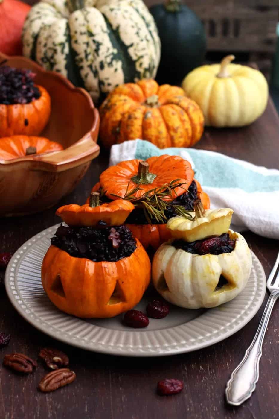 Stuffed Halloween pumpkins with wild rice, on a white plate.
