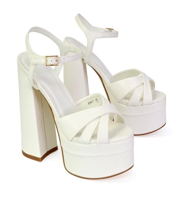 A pair of white high heeled shoes

Description automatically generated with medium confidence