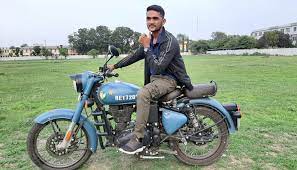 Satyadhi Sharma sitting on his bike
