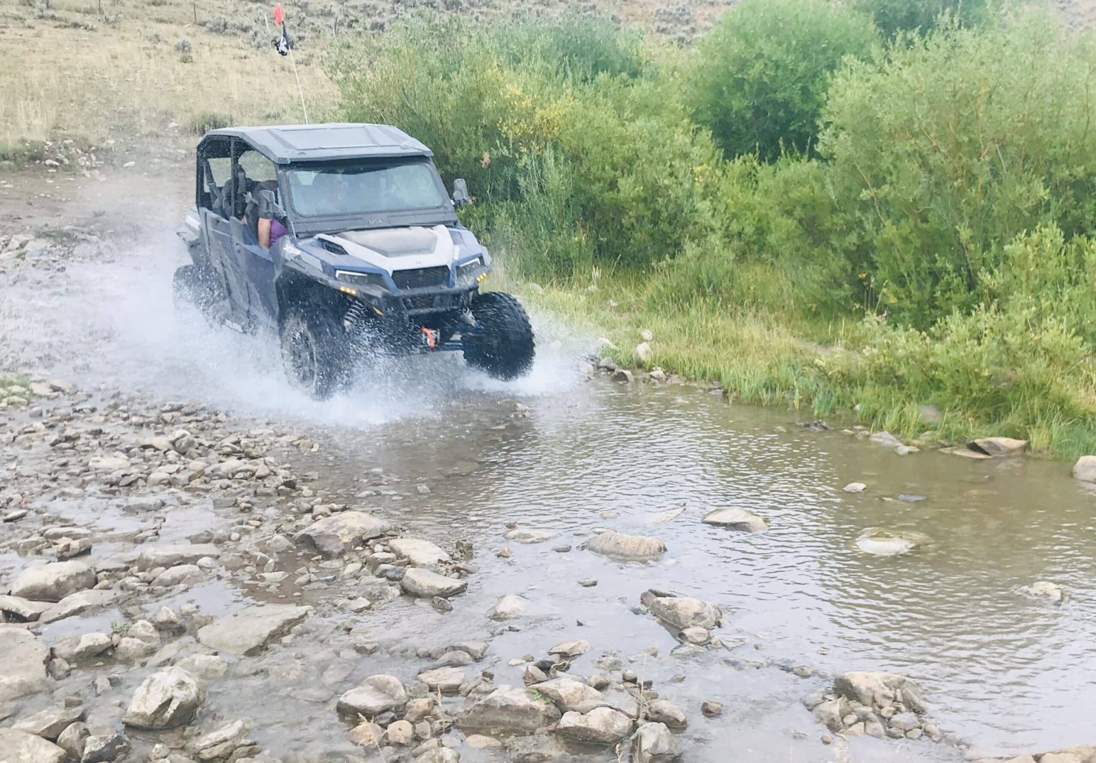 An OHV riding through wet terrain with force