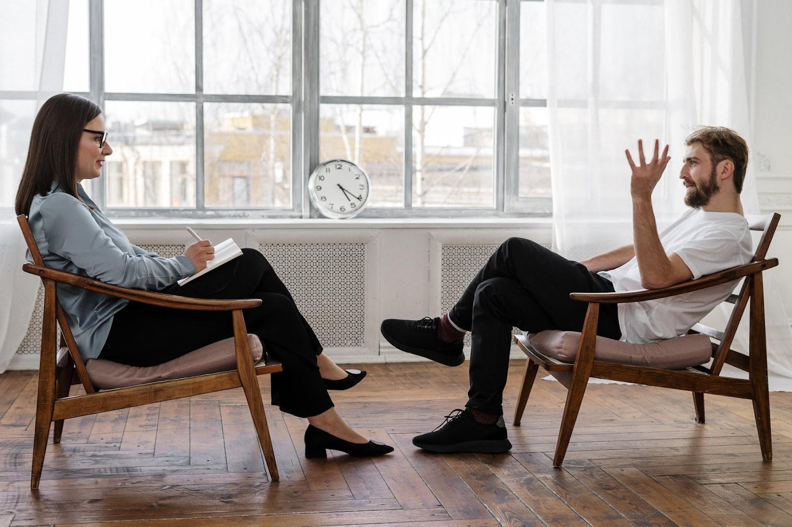 In this image, a therapist sits across from her client, offering Solution-Focused Brief Therapy.