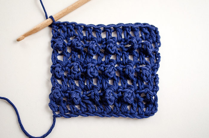 triple crochet loop stitch swatch with hook on white background
