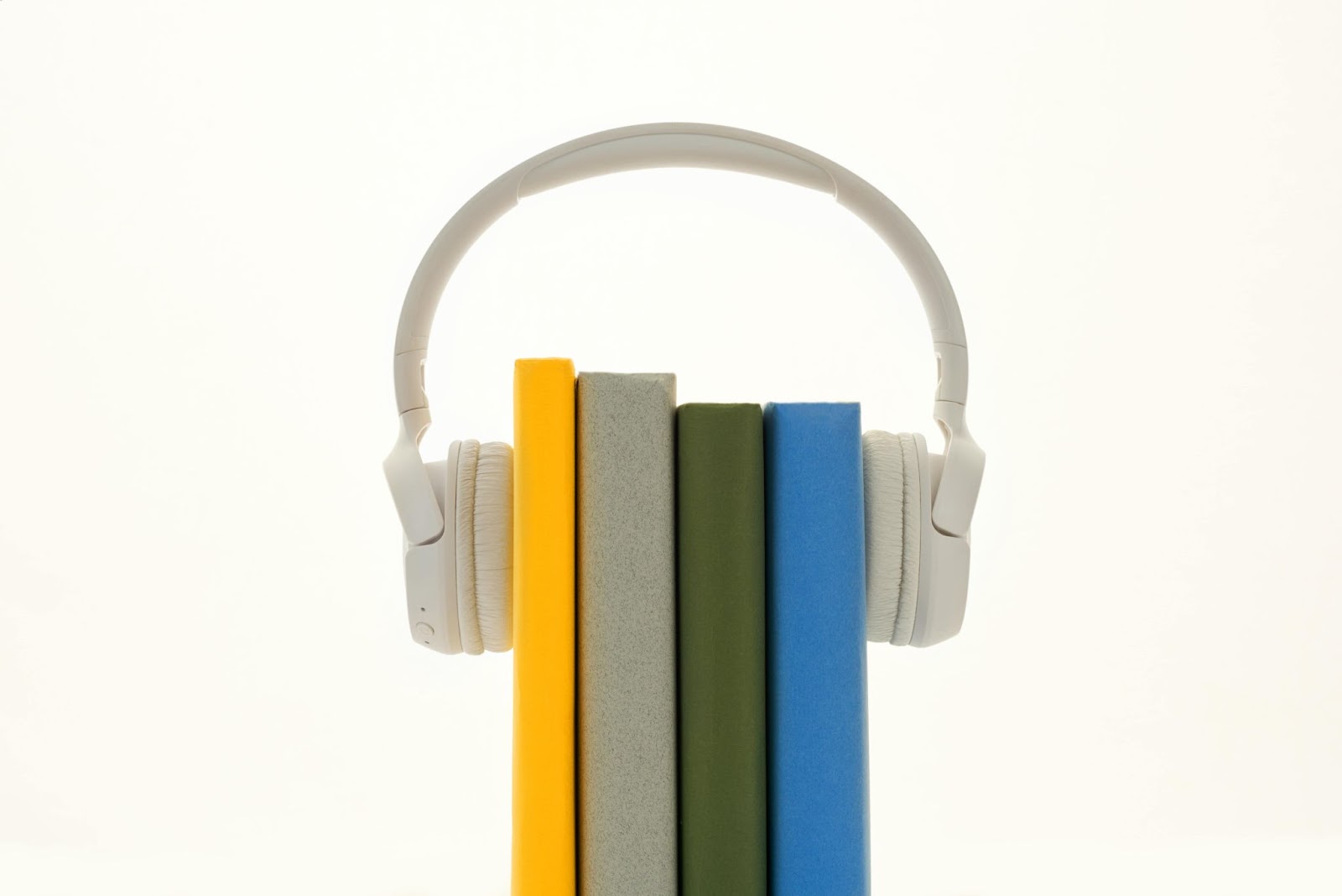 An image of 4 books "wearing" a set of over-ear headphones