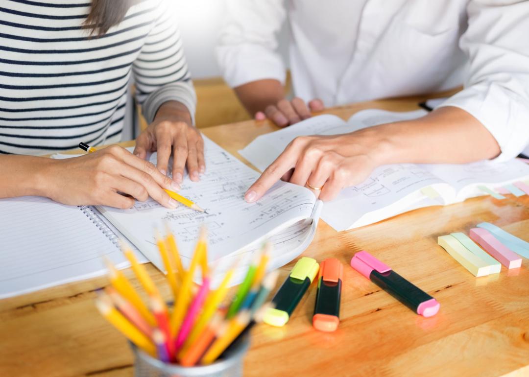 Tutor helping student with math lessons.