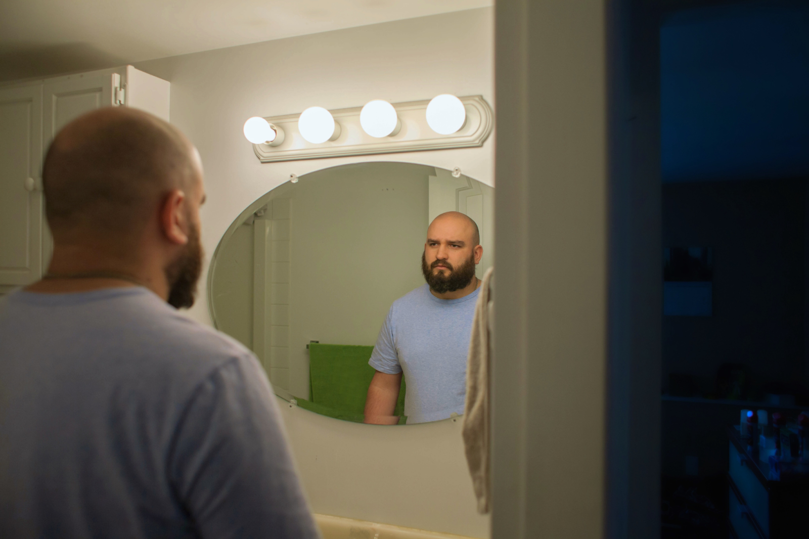guy looking at himself in the mirror 
