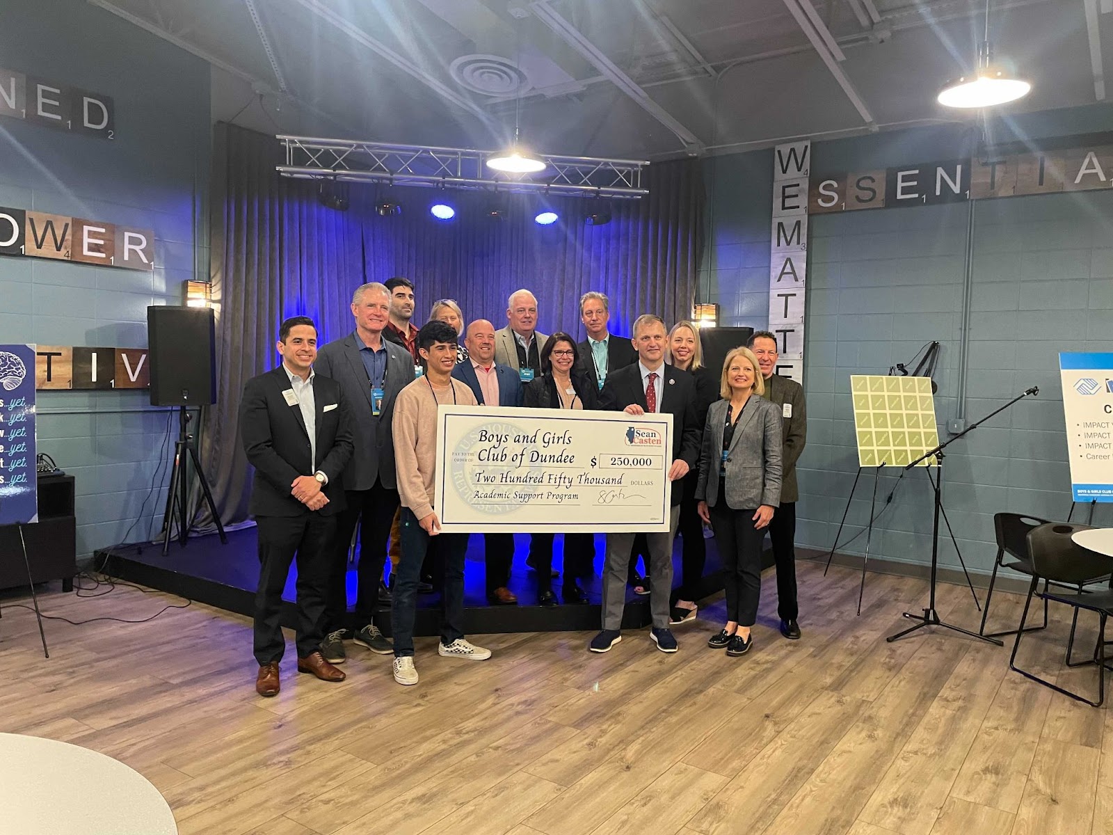 students holding a very large check