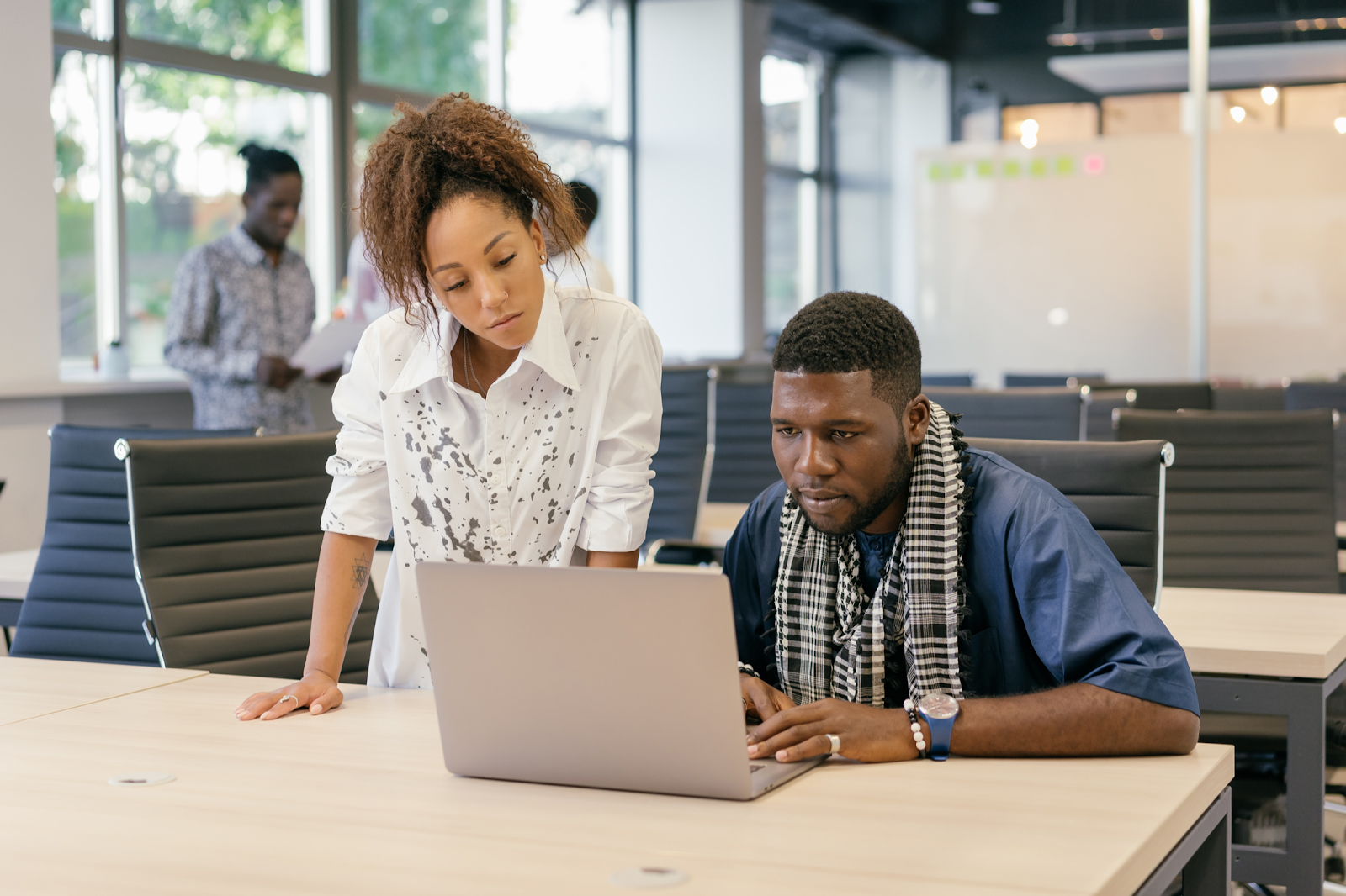 woman and man colleague working on one laptop legal process outsourcing